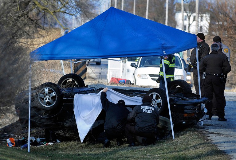 Will County Sheriff's officers begin to investigate the crash at Forked Creek near Wilmington, Ill., Tuesday, March 12, 2013, that took the lives of two boys and two girls, aged 15 to 17, when their car apparently skidded off a bridge into the icy creek. Authorities say the teens had been missing since Monday evening and they don't know exactly when the accident occurred. (AP Photo/Daily Journal, Mike Voss)
