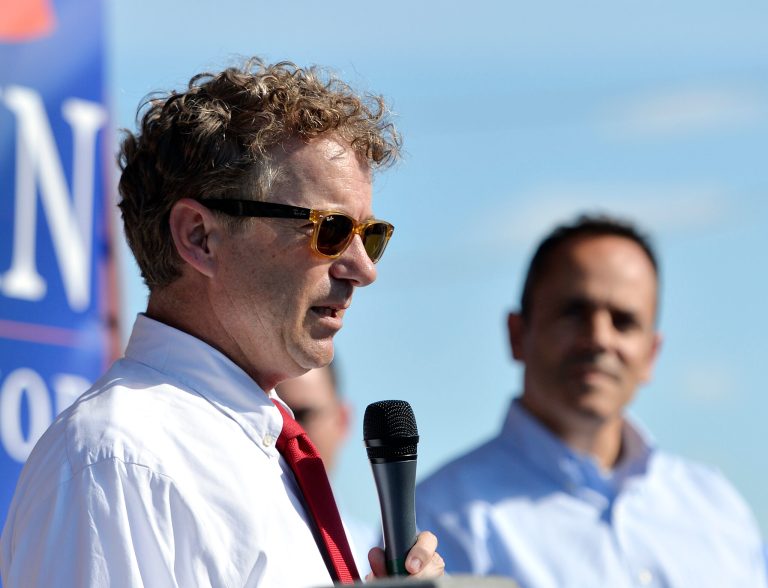 Republican presidential candidate Sen. Rand Paul, R-Ky., left, addresses the crowd as Kentucky Republican Gubernatorial candidate Matt Bevin looks on from the steps of the Bevin campaign headquarters in Somerset Ky., Friday, Aug. 21, 2015. (AP Photo/Timothy D. Easley)
