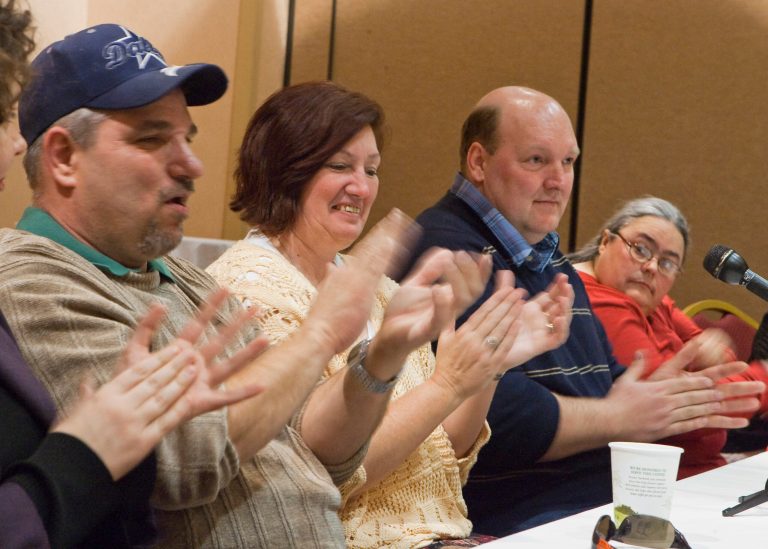James Dean, left, JoAnn Taylor, second left, Thomas Winslow, and Debra Shelden, right, who were among five people pardoned Jan. 26, 2009, for the 1985 gruesome rape and murder of 68-year-old Helen Wilson of Beatrice, applaud during a reception held for them in Lincoln, Neb. (AP File)