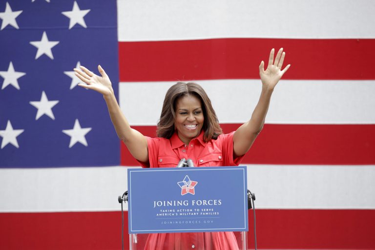 U.S. first lady Michelle Obama waves as she arrives to meet with soldiers and their families at the U.S. Army Garrison Vicenza, northern Italy, Friday, June 19, 2015. (AP Photo/Antonio Calanni)