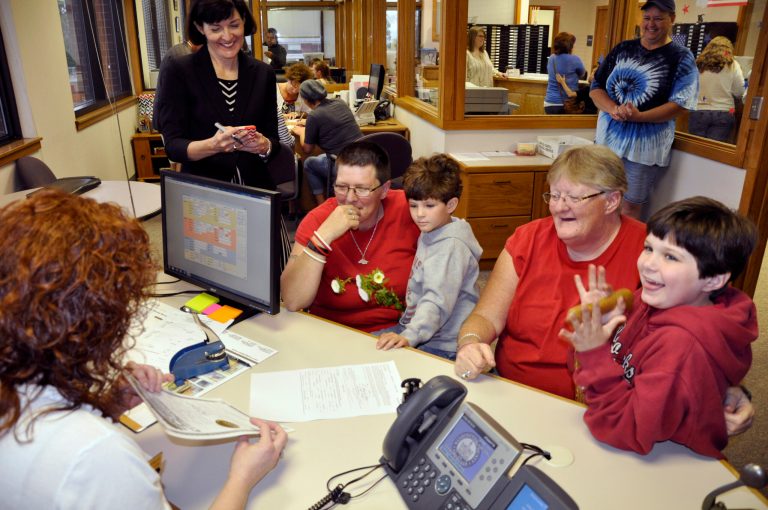 Washington County deputy county clerk Jennifer Sharpshair, far left, shows the competed marriage license to Diana Rister, second right, and Amy Grigg, third left, of Morrow, Ark., on Monday, May 12, 2014, while granddaughters Callie, 9, right, and Harley, 5, look on, in Fayetteville, Ark. Rister and Grigg, who said they've been together for 14 years, were the first in line after the county began issuing licenses to same-sex couples following a judge's ruling overturning the state's ban. (AP Photos/Kurt Voigt)