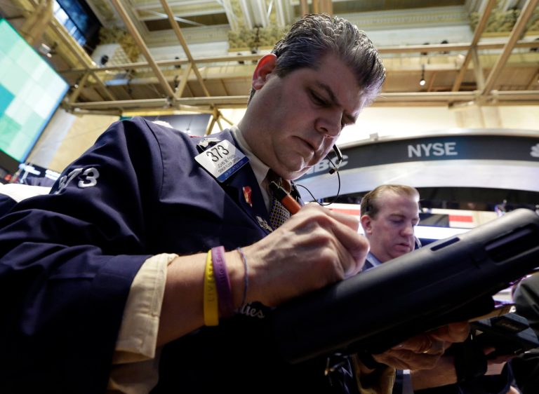 Trader John Panin, left, works on the floor of the New York Stock Exchange Wednesday, March 13, 2013. Investors are calling an end to the past week's remarkable rally, with many cashing in on stocks Wednesday despite more strong economic data out of the U.S. (AP Photo/Richard Drew)