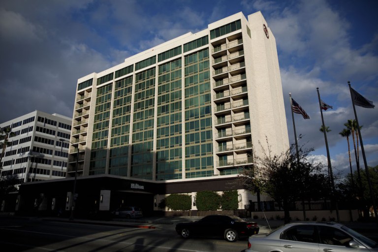 Vehicles pass in front of the Hilton Pasadena hotel in Pasadena, Calif. The hotel company expects to benefit this year as consumers and companies spend extra cash from a GOP-led tax break on travel. Photographer: Patrick T. Fallon/Bloomberg