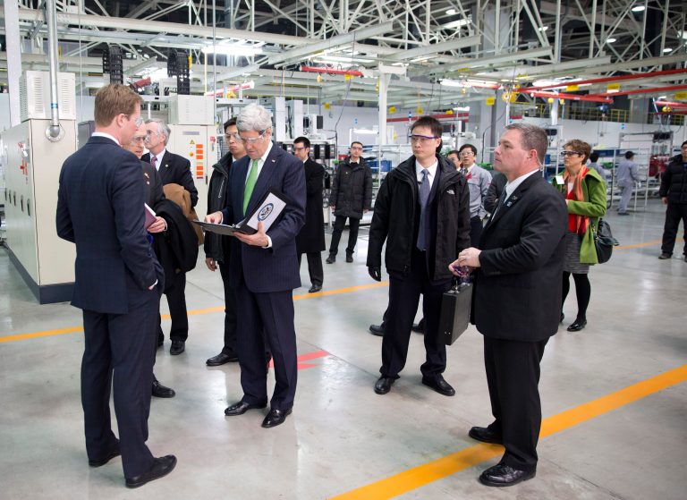 U.S. Secretary of State John Kerry, center left, looks over his notes before delivering remarks on climate change after a tour of the Foton Cummins Engine plant in Beijing, China Saturday, Feb. 15, 2014. Kerry toured the plant and made remarks on climate change cooperation between the United States and China. (AP Photo/Evan Vucci, Pool)