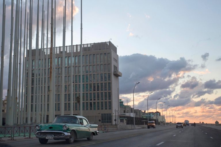 An American classic car passes next to the building of the US Interests Section in Havana, Cuba, Wednesday, Dec. 17, 2014. President Obama announced the re-establishment of diplomatic relations as well as an easing in economic and travel restrictions on Cuba Wednesday, declaring an end to America's 