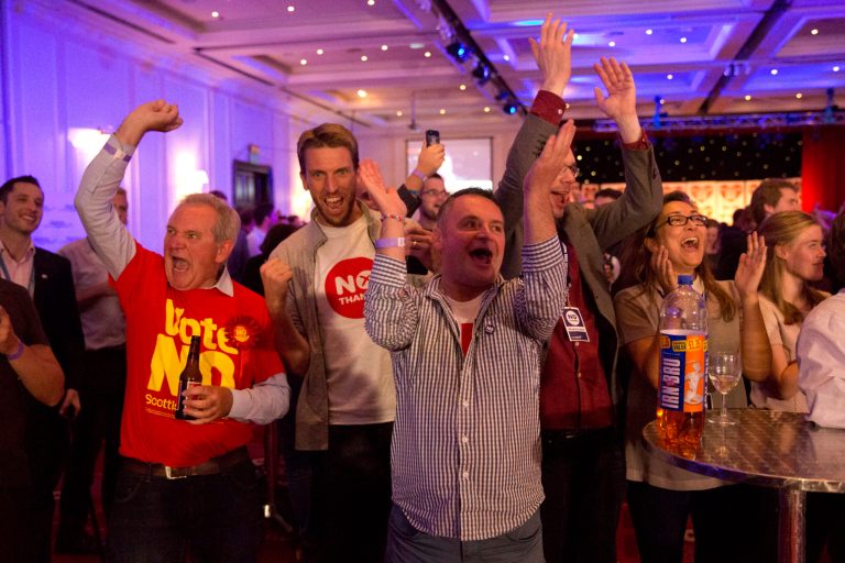 No supporters for the Scottish independence referendum celebrate an early result at a No campaign event at a hotel in Glasgow, Scotland, early Friday, Sept. 19, 2014.  From the capital of Edinburgh to the far-flung Shetland Islands, Scots embraced a historic moment - and the rest of the United Kingdom held its breath - after voters turned out in unprecedented numbers for an independence referendum that could end the country's 307-year union with England.  (AP Photo/Matt Dunham)