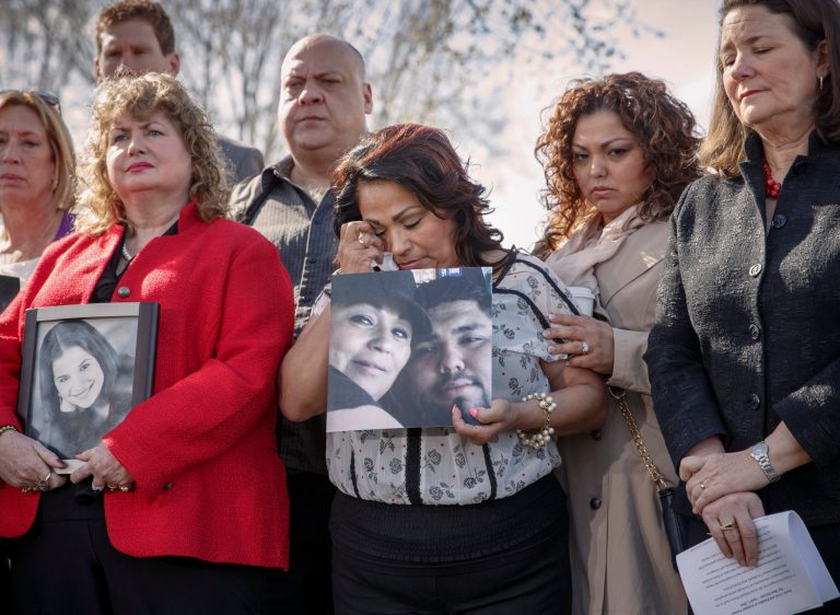 Rosie Cortinas, center, holding a photo of her son, Amador Cortinas, of Homedale, Idaho, who was killed while driving a friend home in a Chevy Cobalt, joins other families whose loved ones died behind the wheel of defective General Motors vehicles, during a news conference on Capitol Hill in Washington, Tuesday. (AP Photo/J. Scott Applewhite)