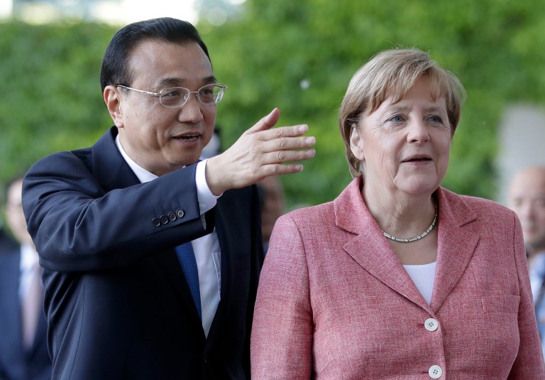 German Chancellor Angela Merkel looks on as China's Premier Li Keqiang, left, gestures. Germany doesn't want a trade war with the U.S. but would respond to tariffs.