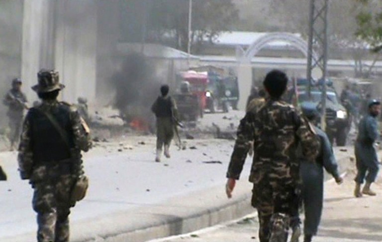 This image made from AP video shows Afghan National Army soldiers rushing to the scene moments after a car bomb exploded in front the PRT, Provincial Reconstruction Team, in Qalat, Zabul province, southern Afghanistan, Saturday, April 6, 2013. Three U.S. soldiers, two U.S. civilians and a doctor were killed when a suicide bomber detonated a car full of explosives just as a convoy with the international military coalition drove past another convoy of vehicles carrying the governor of Zabul province. (AP Photo via AP video)