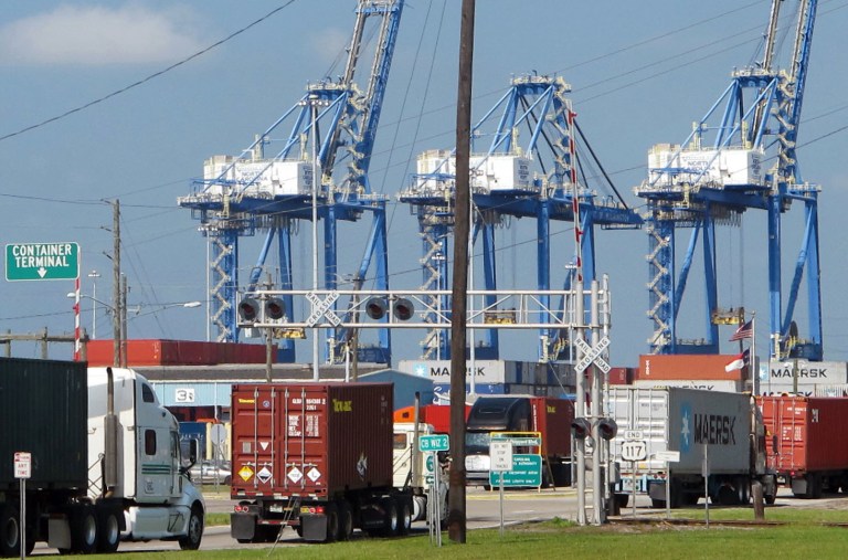   In this July 25, 2013, photo, Trucks move into the container terminal at the Port of Wilmington in Wilmington, N.C. The government reports how much wholesale businesses adjusted their stockpiles in June and how much they collected in sales on Friday, Aug. 9, 2013. (AP Photo/Bruce Smith)  