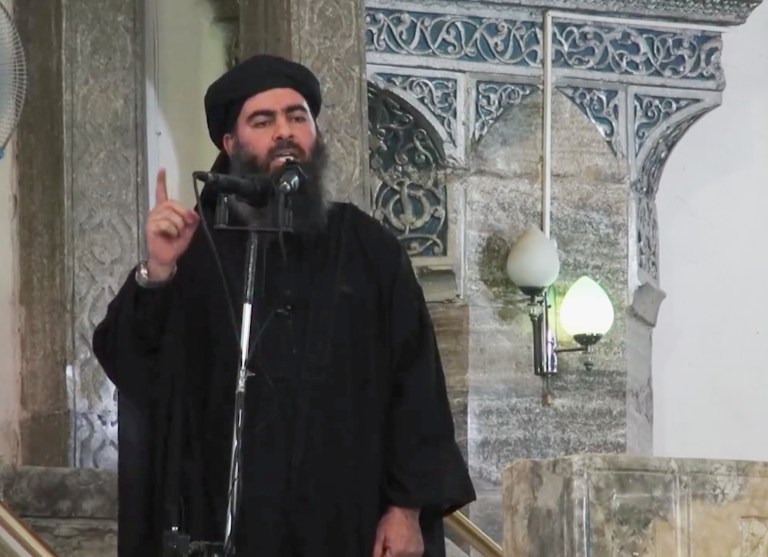 This image made from video posted on a militant website Saturday, July 5, 2014, which has been authenticated based on its contents and other AP reporting, purports to show the leader of the Islamic State group, Abu Bakr al-Baghdadi, delivering a sermon at a mosque in Iraq. A video posted online Saturday purports to show the leader of the Islamic State extremist group that has overrun much of Syria and Iraq delivering a sermon at a mosque in Iraq, in what would be a rare - if not the first - public appearance by the shadowy militant. (AP Photo/Militant video)