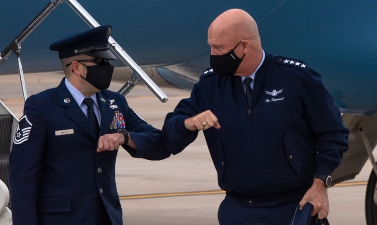 PETERSON AIR FORCE BASE, Colo. â Chief of Space Operations General John W. âJayâ Raymond elbow bumps an Airman after landing at Peterson Air Force Base, Oct. 20, 2020. Raymond visited the Front Range installation preside over the Space Operations Command stand-up Oct. 21, 2020. 