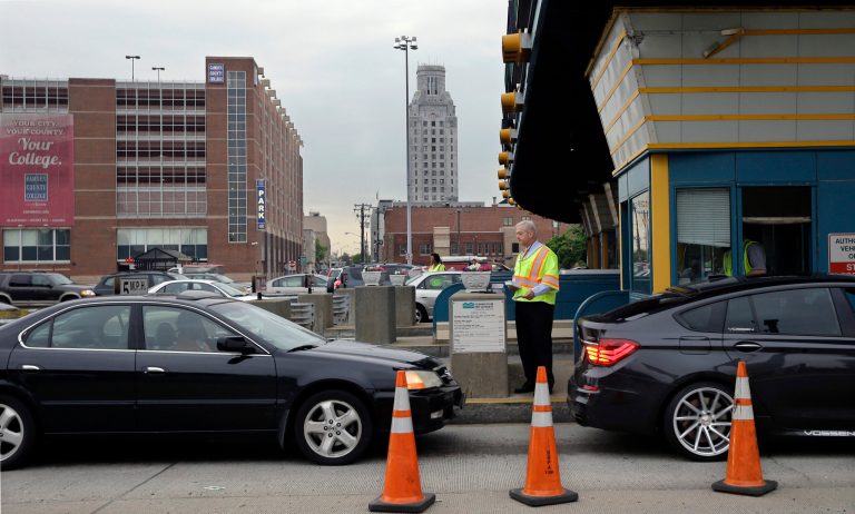 In this May 21, 2014 photo, Delaware River Port Authority CEO John Hanson, hands information cards to drivers in Camden, N.J., at the toll lanes of the Benjamin Franklin Bridge between Camden and Philadelphia. Starting June 3, one of the two sets of PATCO train tracks over the Ben Franklin Bridge will be closed for two months to be replaced. (AP Photo/Mel Evans)