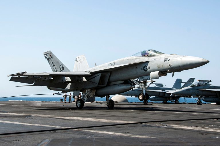In this file Image provided by the U.S. Navy on Tuesday, Sept. 23, 2014, a F/A-18E Super Hornet attached to the Tomcatters of Strike Fighter Squadron (VFA) 31 lands aboard the aircraft carrier USS George H.W. Bush after conducting strike missions against Islamic State group and other targets in Syria. (AP Photo/U.S. Navy, Mass Communication Spc. 3rd Class Brian Stephens-file)