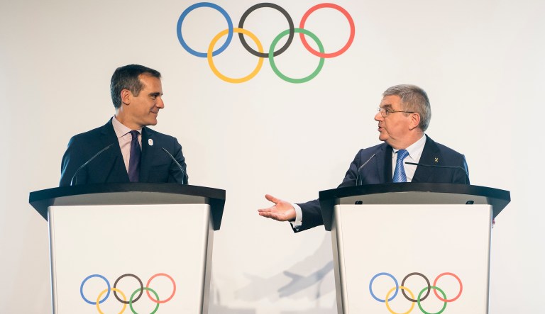 Mayor of Los Angeles Eric Garcetti, left, listens to International Olympic Committee President Thomas Bach from Germany, right, during a visit of the Los Angeles 2024 Candidate City delegation, at the Olympic Museum, in Lausanne, Switzerland. President Trump said Tuesday he is focused on bringing the 2024 Olympic games to Los Angeles. (Jean-Christophe Bott/Keystone via AP)