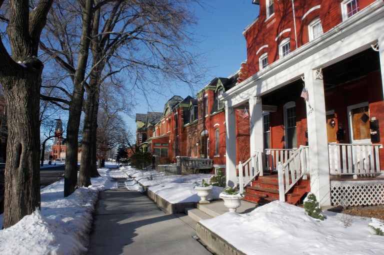 FILE - In this Feb. 13, 2008 file photo, the landmark Pullman Works administration building and its 12-story clock tower is seen at left from the row houses in the Pullman District neighborhood in Chicago. The director of the National Park Service toured the historic neighborhood Thursday, June 14, 2012, to learn more about the site being considered for national park status. The neighborhood was founded by industrialist George Pullman in 1880. It was known for manufacturing Pullman Palace Sleeper Cars, the most luxurious railcar for nearly a century. (AP Photo/Seth Perlman, File)  