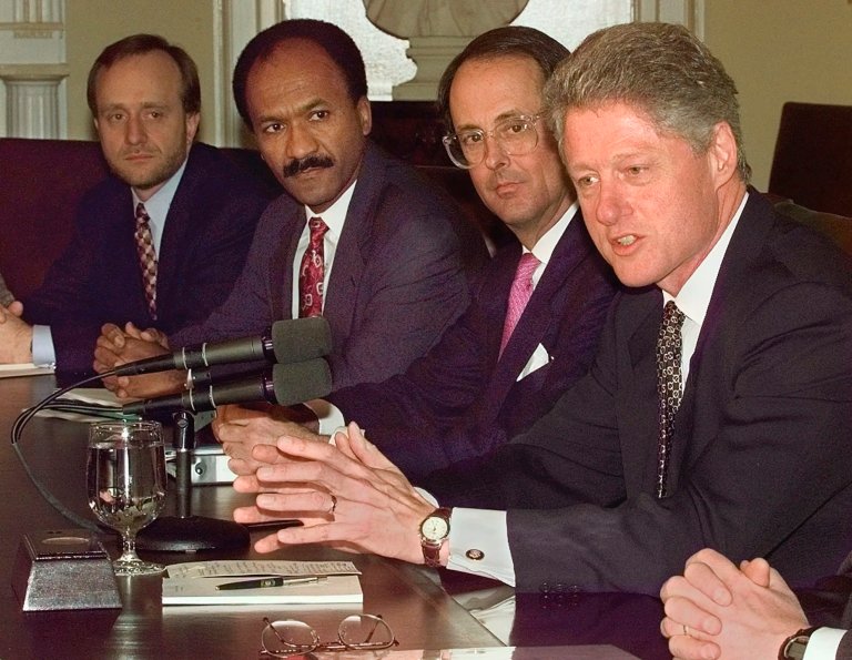 President Bill Clinton discusses budget initiatives with members of his economic team, including adviser Paul Begala, left, during a meeting at the White House in January 1998. (AP Photo/Greg Gibson)