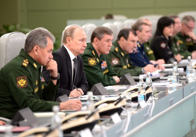 Russian President Vladimir Putin, second left, flanked by Defense Minister Sergei Shoigu, left, and Chief of the General Staff of the Russian Armed Forces Valery Gerasimov, third left, visits the National Defense Control Center in Moscow, Russia, Friday, April 17, 2015. (Alexei Nikolsky/ RIA-Novosti, Kremlin Pool Photo via AP)