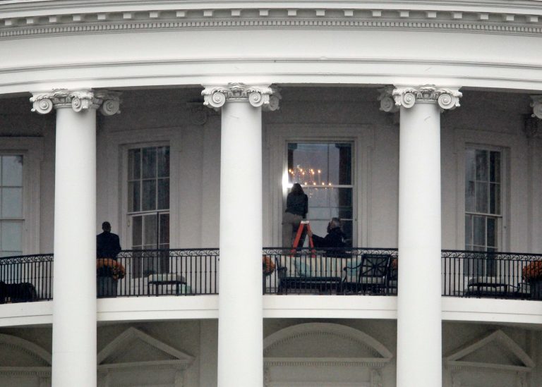 Law enforcement officers photograph a window at the White House in Washington, Wednesday, Nov. 16, 2011, as seen from the South Lawn. A bullet hit an exterior window of the White House and was stopped by ballistic glass, the Secret Service said. An additional round of ammunition was found on the White House exterior. (AP Photo/Haraz N. Ghanbari)
