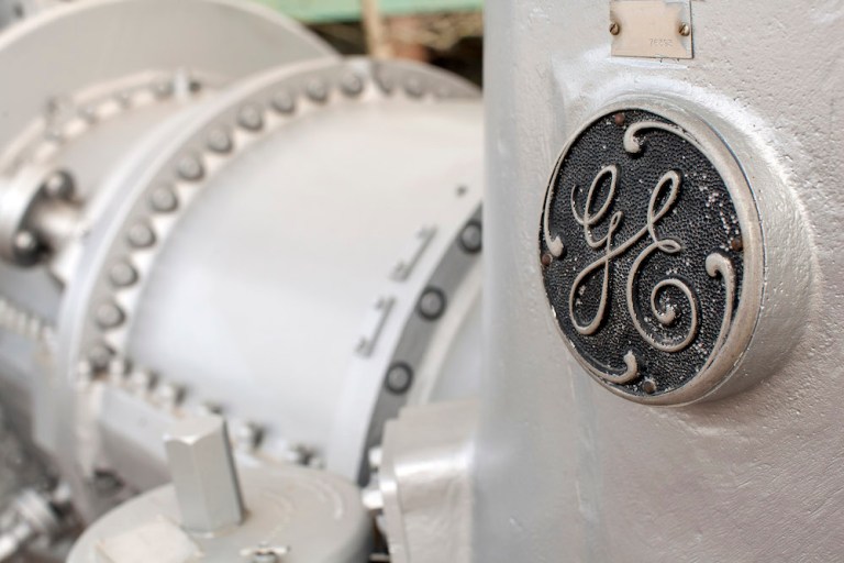 A detail of a GE logo is seen on a gas turbine from the 1940's at the General Electric Co. Power & Water plant in Greenville, South Carolina, U.S., on Wednesday, March 18, 2015. Photographer: Jason E. Miczek/Bloomberg