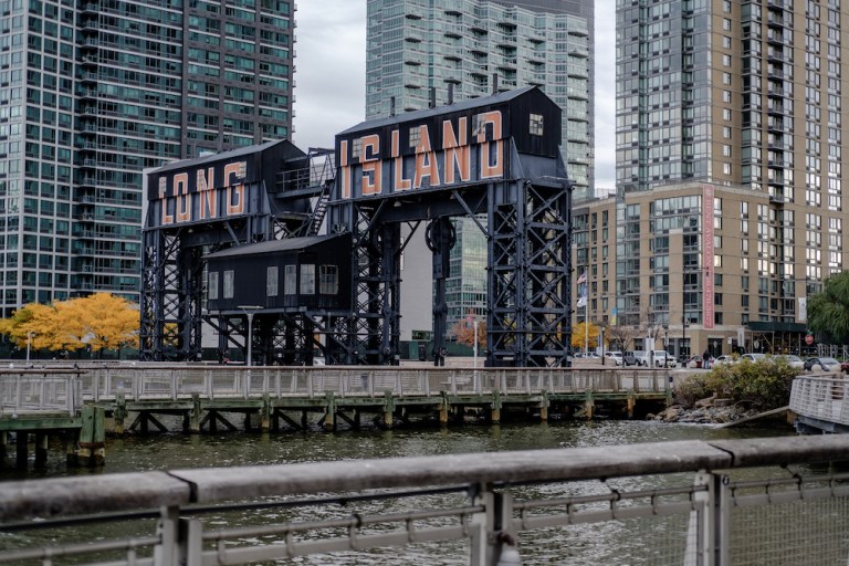 A gantry that reads "Long Island" is seen from Gantry Plaza State Park in the Long Island City neighborhood in the Queens borough of New York, U.S., on Friday, Nov. 9, 2018. As reports emerged this week that Amazon.com Inc. was close to an agreement to set up aÂ new office hubÂ in Long Island City, the prospect of all those jobs, shoppers, and potential tenants or homebuyers drew cheers in the fast-growing neighborhood across the East River from Manhattan. 