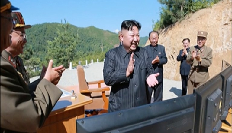 North Korea leader Kim Jung Un applauds after the launch of an intercontinental ballistic missile. The majority of voters disapprove of President Trump's handling of the current situation with the rogue regime. (KRT via AP Video, File)
