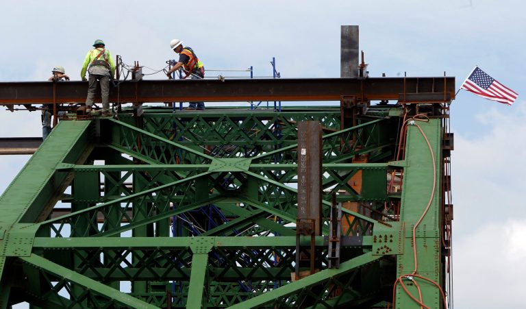   Workers perch on the structure of the Checkered House Bridge on Monday, June 18, 2012 in Richmond, Vt. Engineers are in the process of widening an historic, narrow Vermont bridge as part of renovations designed to make it safe for 21st century travelers. Engineers are planning to widen the 1929 bridge 12 ? feet as part of plan to renovate and modernize it. The truss that is being moved weighs about 300,000 pounds. (AP Photo/Toby Talbot)  