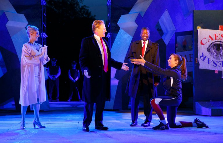 In this May 21, 2017 photo provided by The Public Theater, Tina Benko, left, portrays Melania Trump in the role of Caesar's wife, Calpurnia, and Gregg Henry, center left, portrays President Donald Trump in the role of Julius Caesar during a dress rehearsal of The Public Theater's Free Shakespeare in the Park production of Julius Caesar, in New York. Rounding out the cast on stage is Teagle F. Bougere as Casca, and Elizabeth Marvel, right, as Marc Anthony. (Joan Marcus/The Public Theater via AP)