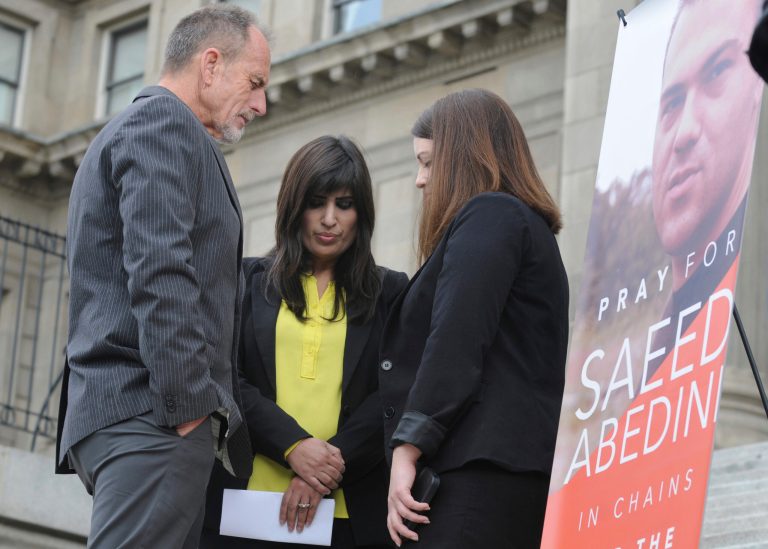 Calvary Chapel of Boise Pastor Bob Caldwell, left, prays with Naghmeh Abedini, center, wife of Saeed Abedini, and Tiffany Barrans, with the American Center for Law and Justice on the steps of the Capitol building in Boise, Idaho. (AP Photo/Idaho Press-Tribune, Adam Eschbach)