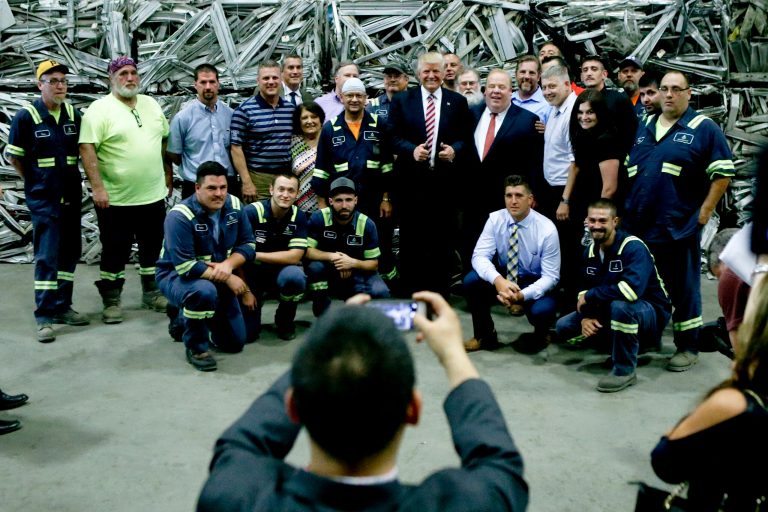 Republican presidential candidate Donald Trump, center, poses with employees after a campaign stop on June 28 at Alumisource, a metals recycling facility in Monessen, Pa. (AP Photo/Keith Srakocic)
