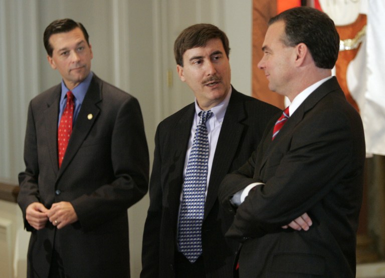 Then-Virginia Attorney General Jerry Kilgore, left, looks on as debate moderator and University of Virginia political science professor Larry J Sabato, center, and then-Lt. Gov. Tim Kaine, right, talk prior to a debate sponosred by the Virginia Associated Press Managing Editors Association in Richmond, Va., Wednesday, Dec. 8, 2004. (AP Photo/Steve Helber)