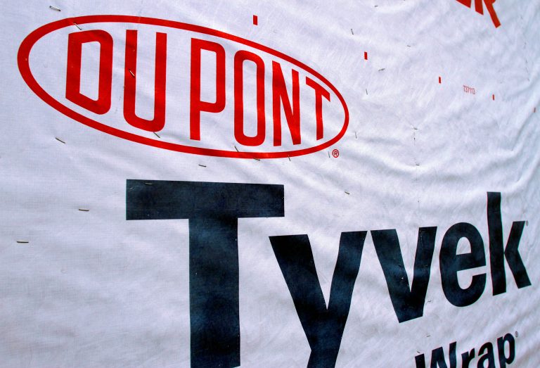 FILE - This Jan. 23, 2012 file photo shows the Dupont logo on sheets of Tyvek insulation covering the outside wall of a home under construction in Springfield, Ill. Dupont reports quarterly financial results before the market opens on Tuesday, July 22, 2014.