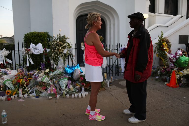 Kathy Atteberry and George Washington share a moment in front of the Emanuel African Methodist Episcopal Church after a mass shooting at the church killed nine people, on June 22, 2015. (Photo by Joe Raedle/Getty Images)