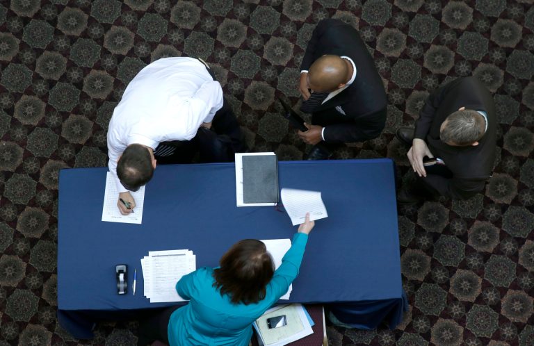 FILE - In this Wednesday, Jan. 22, 2014, file photo, job seekers sign in before meeting prospective employers during a career fair at a hotel in Dallas. The Labor Department reports on the number of people who applied for unemployment benefits for the first week of February on Thursday, Feb. 6, 2014. (AP Photo/LM Otero, File)