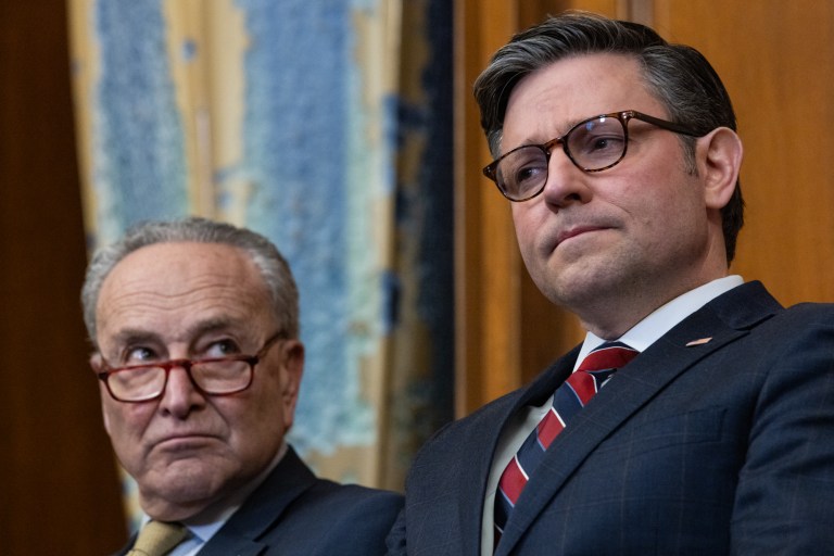 Senate Majority Leader Chuck Schumer (D-NY, left) and Speaker of the House Mike Johnson (R-LA, right) attend a Capitol Menorah lighting ceremony in Washington on Dec. 12, 2023.