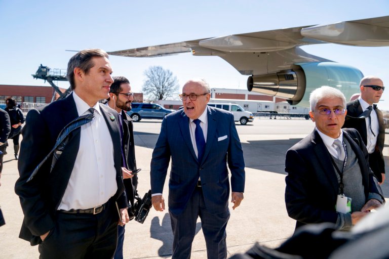 Former New York Mayor Rudy Giuliani, center, boards Air Force One at Douglas International Airport in Charlotte, N.C., Friday, March 2, 2018, to travel to Palm Beach, Fla. (AP Photo/Andrew Harnik)