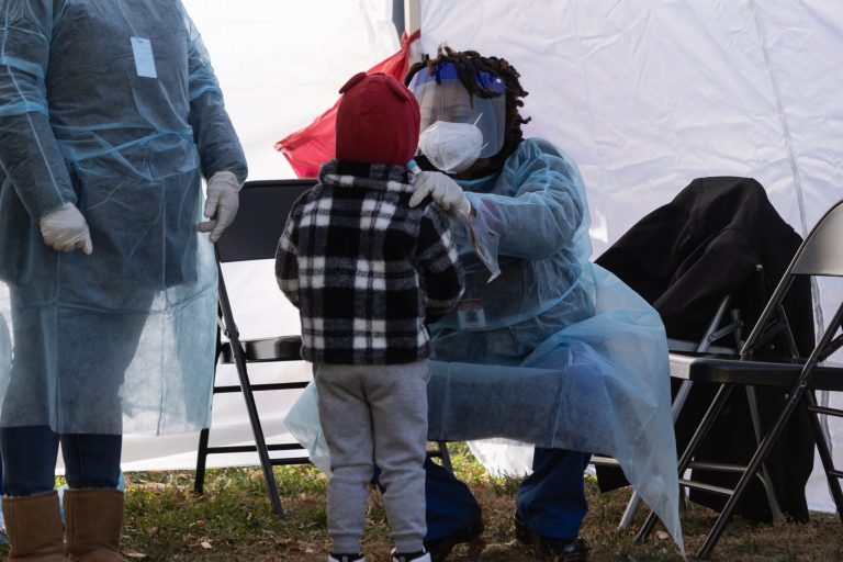 A healthcare worker conducts a COVID-19 test at a walk-up location in Farragut Square in Washington, D.C., on December 23.
