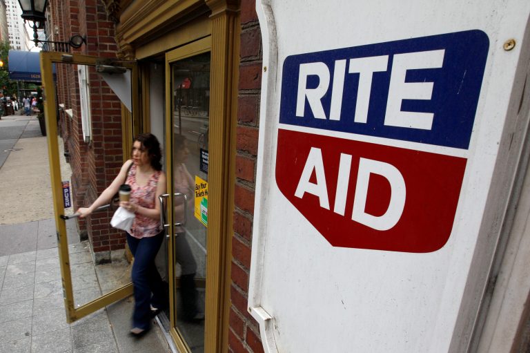 FILE - In this June 20, 2011 file photo, a woman exits a Rite Aid store, in Philadelphia. Rite Aid on Thursday, April 10, 2014 reported its sixth-straight quarterly profit and announced an acquisition that aims to strengthen the drugstore chain's foothold in the burgeoning health care market. (AP Photo/Matt Rourke, File)