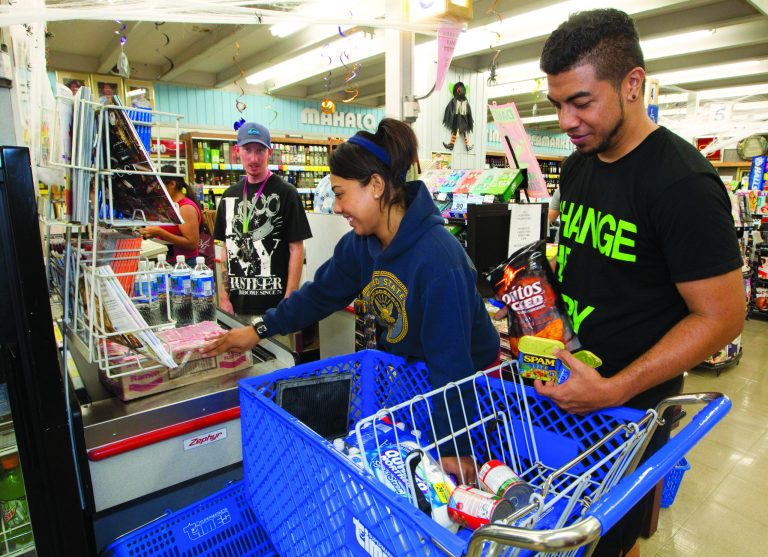 Erica Avegalio, center, and her brother Albert Avegalio, right, load up on water and food at the Times Supermarket after learning of a tsunami warning Saturday, Oct. 27, 2012, in Honolulu. A tsunami warning has been issued for Hawaii after a 7.7-magnitude earthquake rocked an island off the west coast of Canada. The Pacific Tsunami Warning Center originally said there was no threat to the islands, but a warning was issued later Saturday and remains in effect until 7 p.m. Sunday. A small craft advisory is in effect until Sunday morning. (AP Photo/Eugene Tanner)