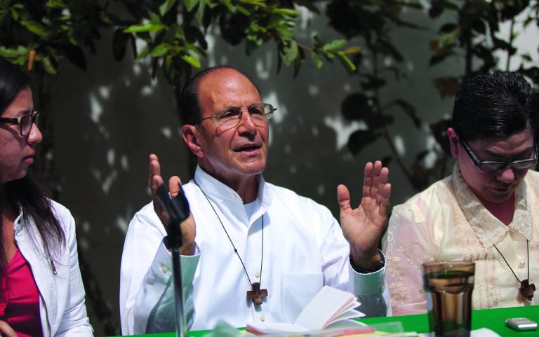 FILE - In this May 15, 2012 file photo, Rev. Alejandro Solalinde gives a press conference in Mexico City. The Roman Catholic priest who has defied drug cartels and corrupt police to protect Central American migrants says church authorities have asked him to leave his work at migrant shelters. Solalinde says the bishop of his diocese in southern Mexico has told him he was gaining too much attention with his public complaints and wants to reassign him to parish duties. On Wednesday, Aug. 8, 2012, Solalinde said that he will ask church authorities to assign him to another migrant shelter. (AP Photo/Alexandre Meneghini, File)