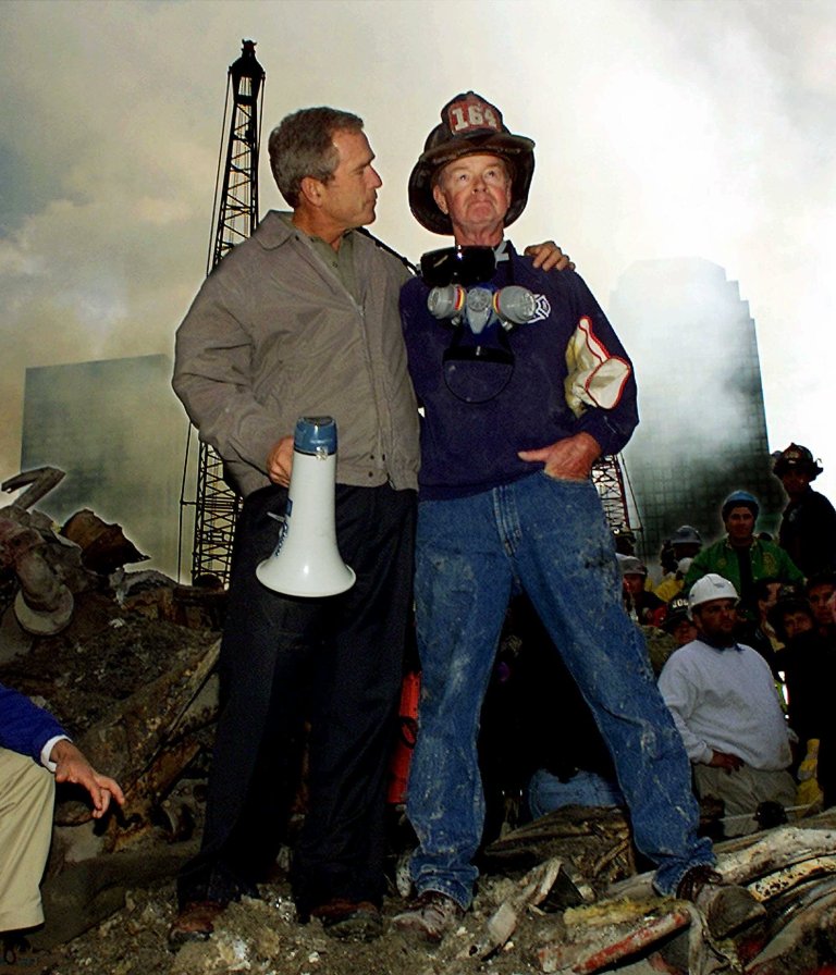 Liberal critics have joined Donald Trump in questioning former President Bush's 9/11 handling. Bush is shown here withÂ firefighter Bob Beckwith while standing in front of the World Trade Center in New York during a tour of the devastation. (AP Photo/Doug Mills)