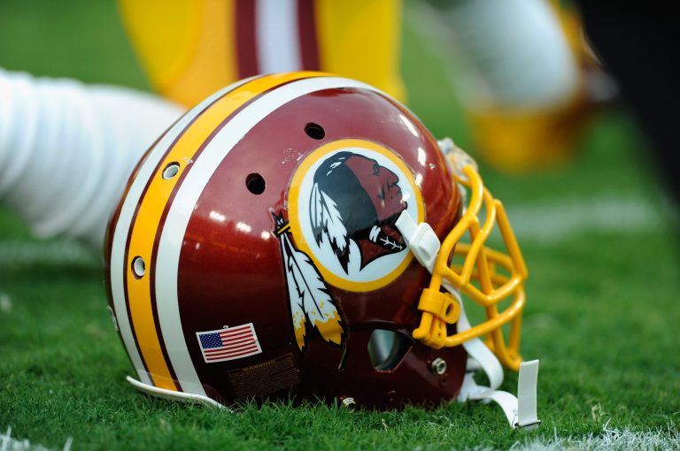 A Washington Redskins helmet sits on the grass during a preseason football game between the Redskins and Cleveland Browns at FedExField on August 18, 2014 in Landover, Maryland. (Photo by TJ Root/Getty images)
