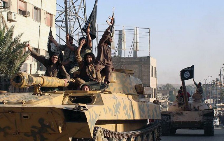 FILE- This undated image posted by the Raqqa Media Center, a Syrian opposition group, June 30, 2014, which has been verified and is consistent with other AP reporting, shows fighters from the al-Qaida linked Islamic State group during a parade in Raqqa, Syria. President Barack Obama presses ahead with his campaign to diminish and defeat Islamic State group extremists in Iraq and Syria, but the list of radical Islamic elements the United States and many of its coalition allies are fighting does not stop there.   (AP Photo/Raqqa Media Center- File)