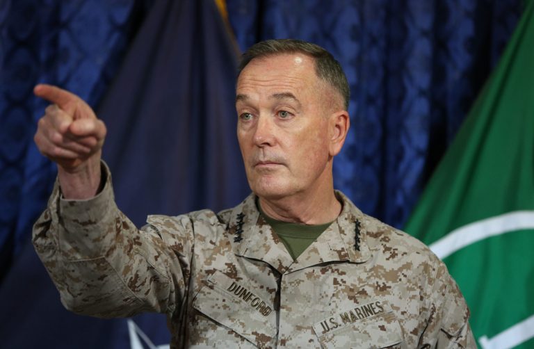 Top U.S. and coalition commander in Afghanistan, Gen. Joseph Dunford, points during a news conference at the ISAF Headquarters in Kabul, Afghanistan, Wednesday, May 28, 2014. Gen. Dunford says that President Barack Obama's decision to keep about 10,000 American troops in the country past 2014 has eliminated any uncertainty Afghans may have had about America's commitment. Gen. Joseph Dunford told reporters Wednesday the decision will allow an advisory force of 9,800 troops to remain in the country to finish training and equipping Afghan security forces. (AP Photo/Massoud Hossaini)