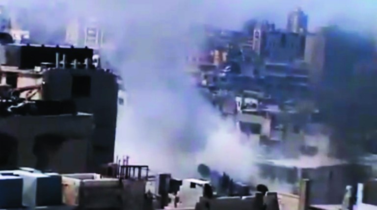 In this image made from amateur video released by the Ugarit News and accessed Monday, July 23, 2012, smoke rises from buildings in Homs, Syria. (AP Photo/Ugarit News via AP video) TV OUT, THE ASSOCIATED PRESS CANNOT INDEPENDENTLY VERIFY THE CONTENT, DATE, LOCATION OR AUTHENTICITY OF THIS MATERIAL