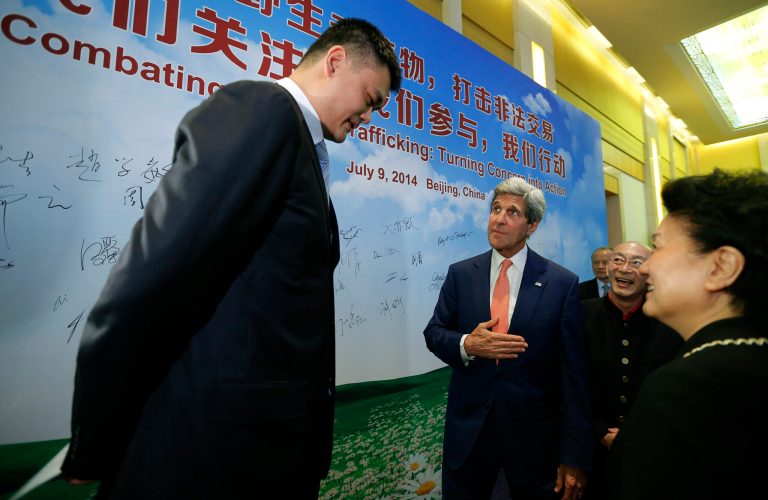 U.S. Secretary of State John Kerry, center, talks with retired Chinese basketball star Yao Ming, left, about his efforts against international wildlife trafficking as the two participate in an event about combating trade of animal remains, during the U.S.-China Strategic and Economic Dialogue at the Diaoyutai State Guesthouse in Beijing, Wednesday, July 9, 2014.  (AP Photo/Jim Bourg, Pool)