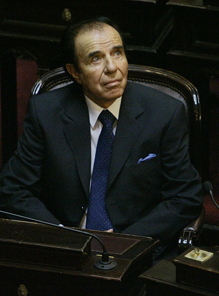 FILE - In this Nov. 29, 2005 file photo, Former Argentine President Carlos Menem attends his swearing-in ceremony as senator for La Rioja province at the National Congress in Buenos Aires, Argentina. Menem was sentenced Thursday, June 13, 2013, to 7 years in prison for smuggling weapons to Ecuador and Croatia in violation of international embargoes in the 1990s. The court also banned Menem from holding elective office, and asked the Senate to vote to remove the immunity he has enjoyed for years as senator. (AP Photo/Natacha Pisarenko, File)