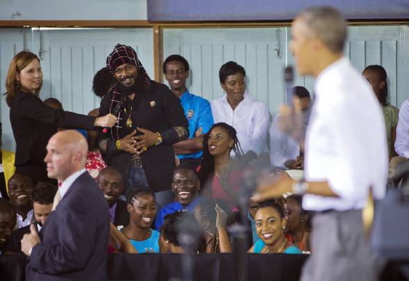 An audience member, left, asks President Obama a question about the legalization of Marijuana during a town hall meeting at the University of the West Indies in Kingston, Jamaica. (AP Photo)Â 