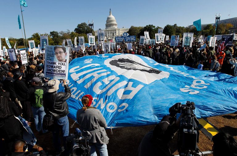 Demonstrators rally near the U.S. Capitol in Washington to demand that Congress investigate the National Security Agency's mass surveillance programs Saturday, Oct. 26, 2013. ( AP Photo/Jose Luis Magana)