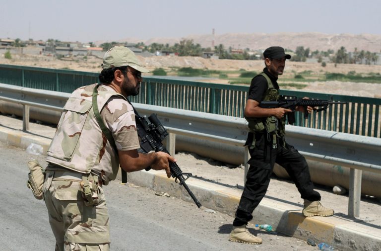 Iraqi security forces and Shiite militiamen patrol in Amirli, some 105 miles north of Baghdad, Iraq, Sunday, Aug. 31, 2014. (AP Photo)